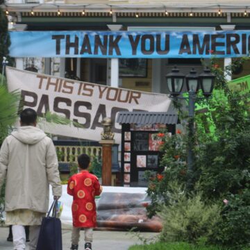 A man and child stand in front of the Viet Museum in San Jose, California
