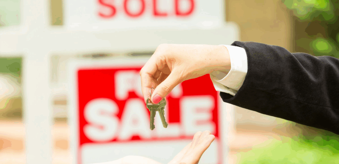 SCC Association of Realtors A hand passes house keys to another hand with a for sale sign in the background