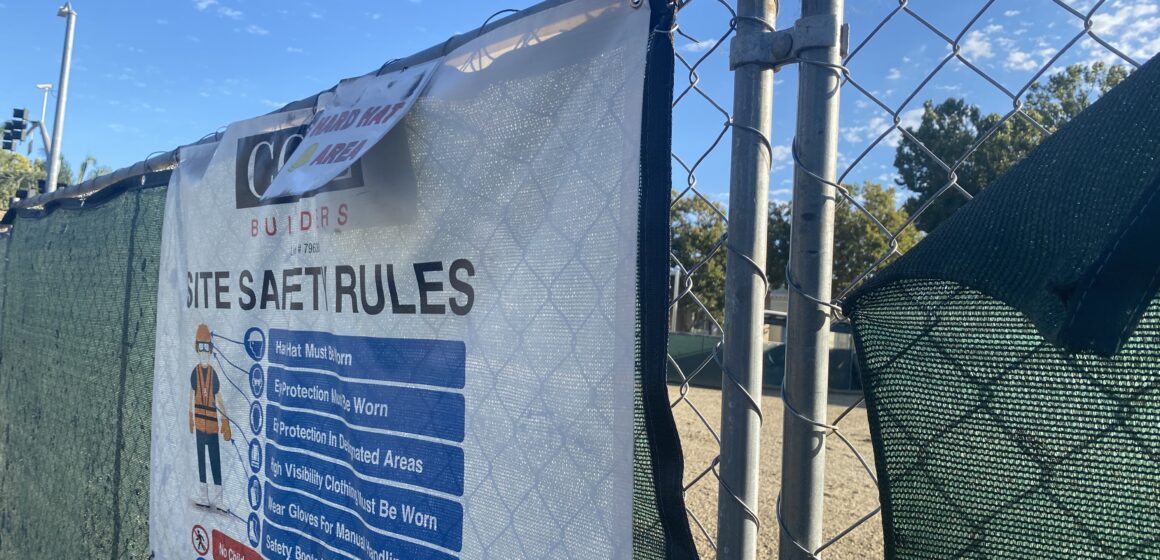 A chain link fence around a development site