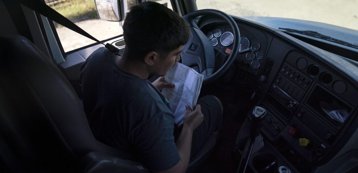A student driver prepares for a driving session at a truck driving academy in California