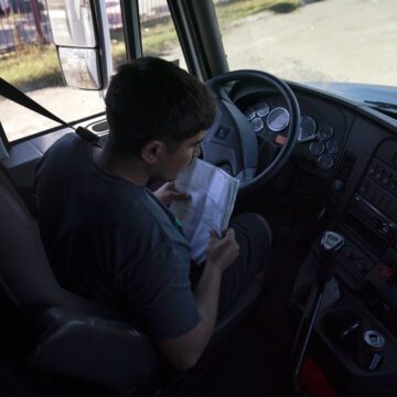 A student driver prepares for a driving session at a truck driving academy in California