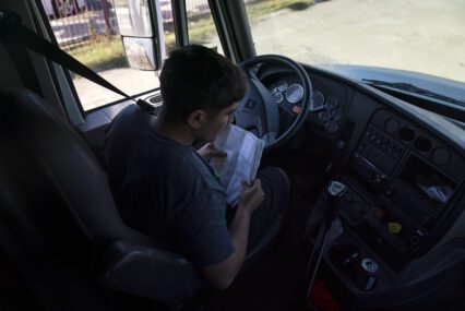 A student driver prepares for a driving session at a truck driving academy in California