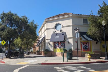The outside of a one-story commercial building with an awning
