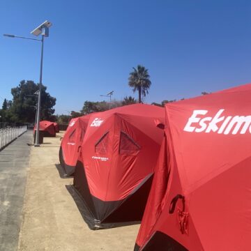A row of tents for homeless residents in a designated sleeping site in San Jose, California