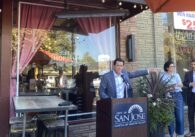 A man speaking at a podium outside