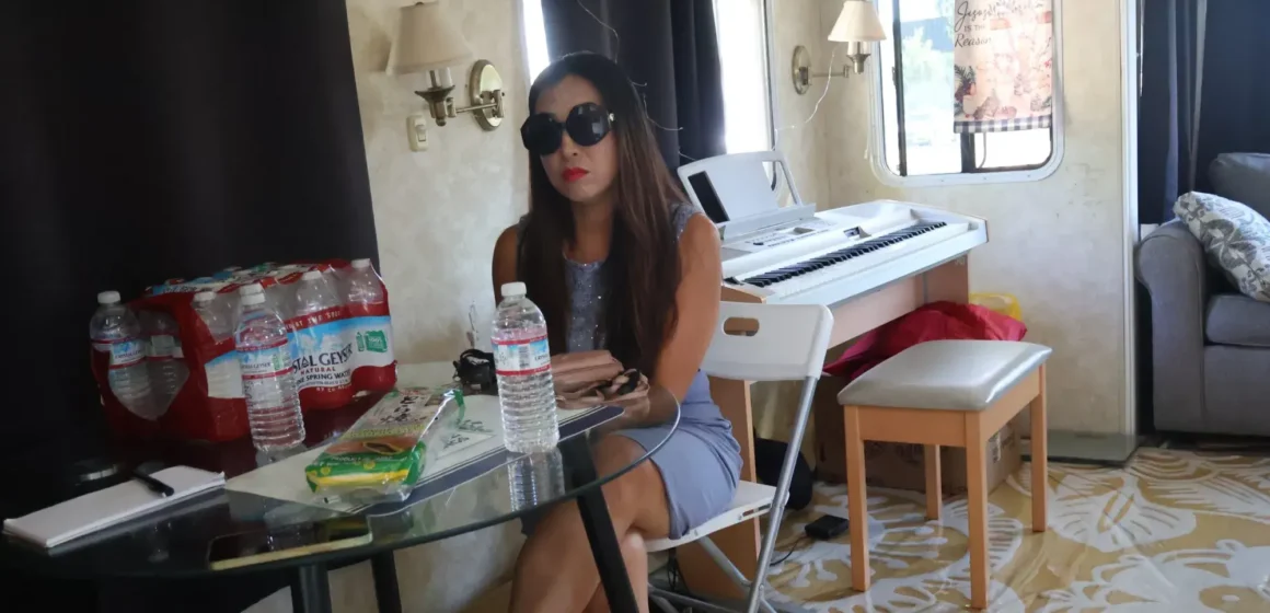 A woman wearing sunglasses sitting down at a table