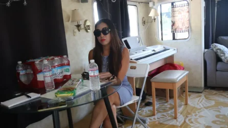 A woman wearing sunglasses sitting down at a table
