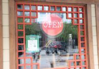 An open sign hanging in a restaurant window in San Jose, California