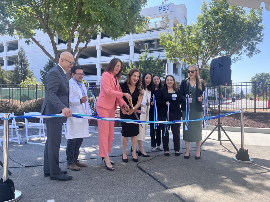 A group of people cutting a ribbon at the opening of a new substance use facility in San Jose, California
