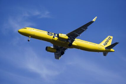 A yellow airplane in the sky