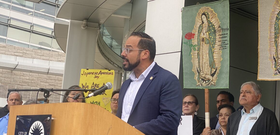 A man speaking at a podium outside San Jose City Hall