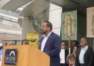 A man speaking at a podium outside San Jose City Hall
