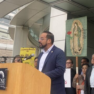 A man speaking at a podium outside San Jose City Hall