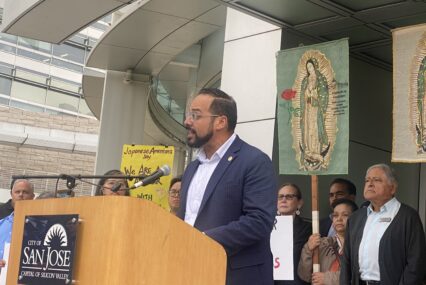 A man speaking at a podium outside San Jose City Hall