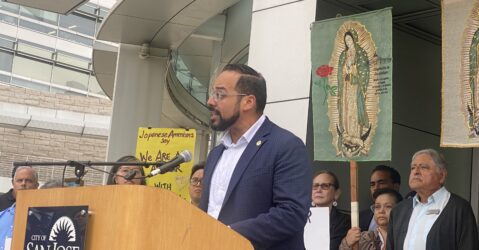 A man speaking at a podium outside San Jose City Hall