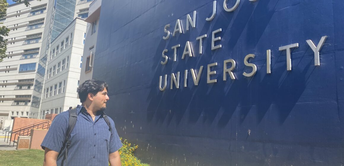 CHARLIE KIRK SJSU--Roberto Rojas A student stands in front of a sign at San Jose State University