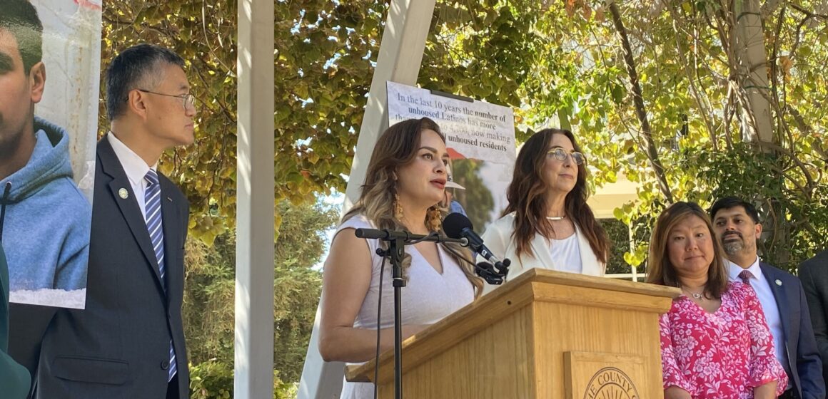 A woman speaks at a podium outside in San Jose, California