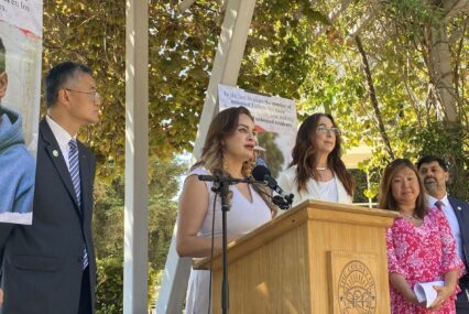 A woman speaks at a podium outside in San Jose, California