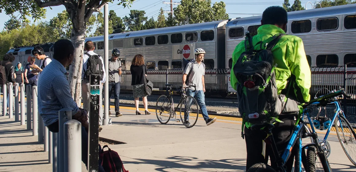 People walking and waiting for a train at a station in Palo Alto, California