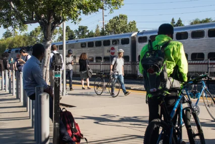 People walking and waiting for a train at a station in Palo Alto, California