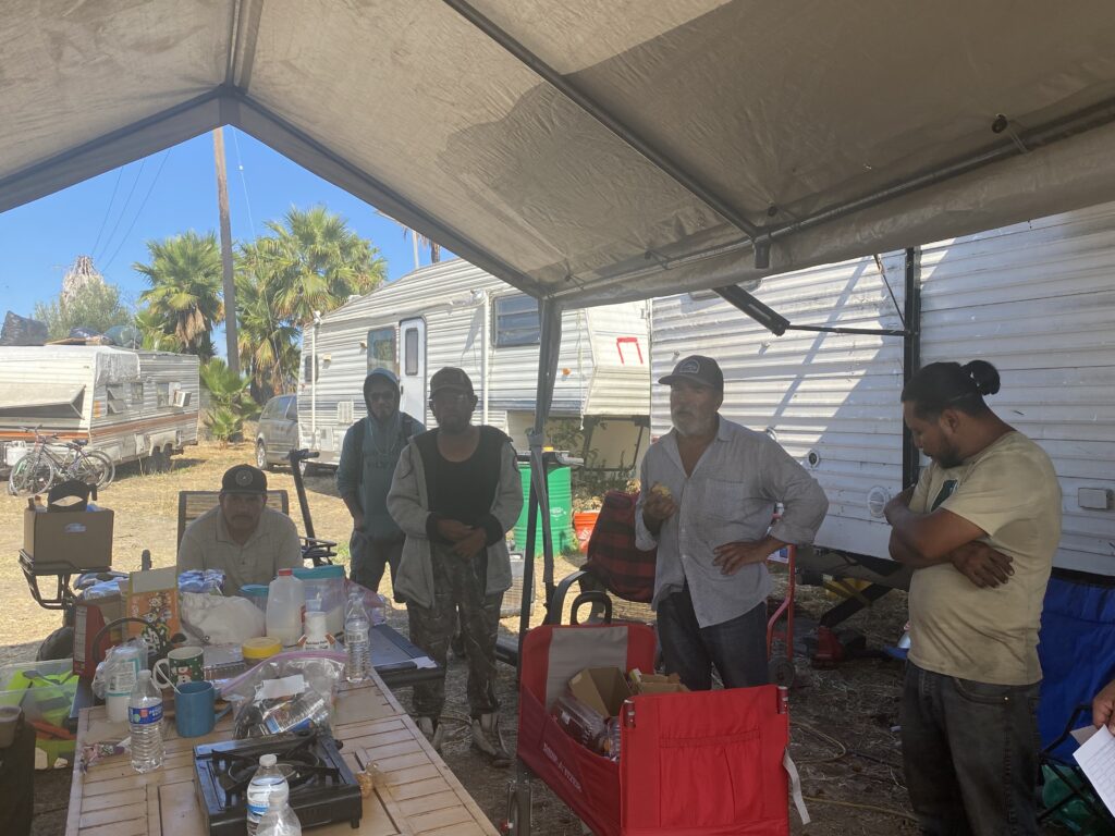 A group of people in a homeless encampment in San Jose, California