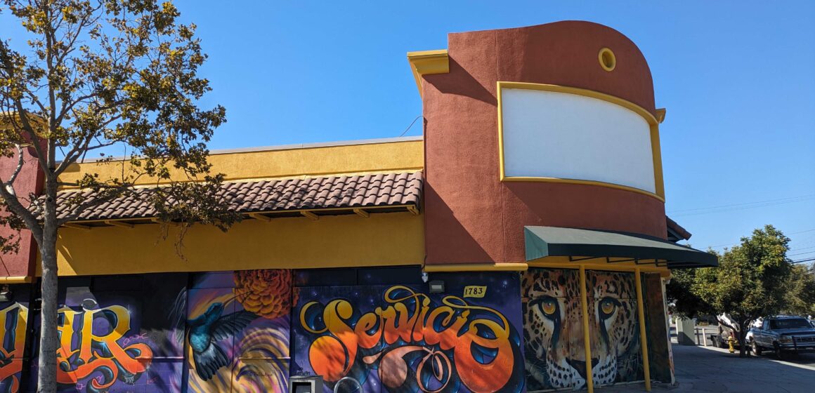 A building in East San Jose, California with murals on the side
