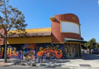 A building in East San Jose, California with murals on the side