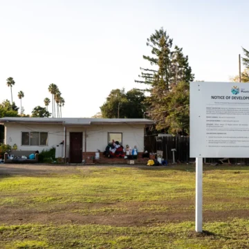 MV Condo Embarcadero A sign on a green lawn in front of a house