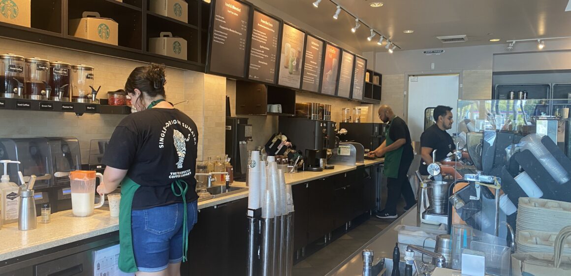 Baristas work behind the counter at a Starbucks coffee shop in Campbell, California