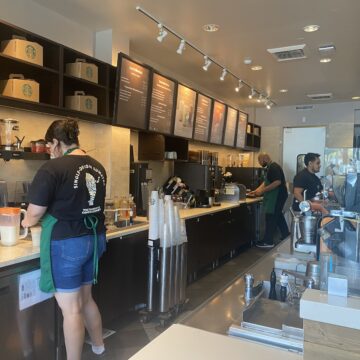Baristas work behind the counter at a Starbucks coffee shop in Campbell, California