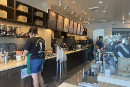 Baristas work behind the counter at a Starbucks coffee shop in Campbell, California