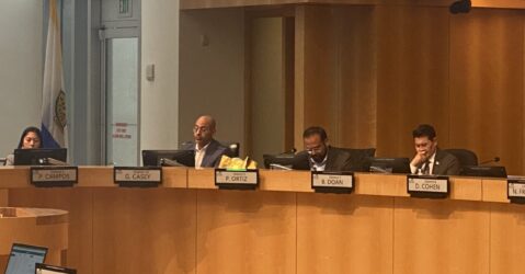 Four people sitting behind the dais at a government meeting in San Jose, California