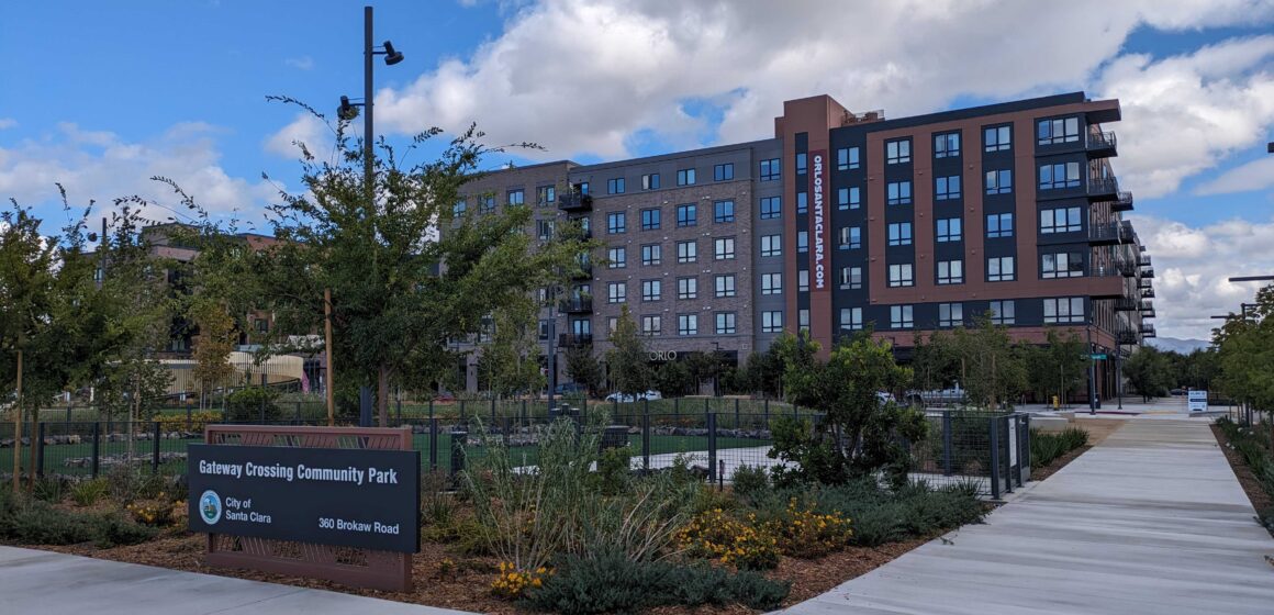A seven-story apartment building behind a community park