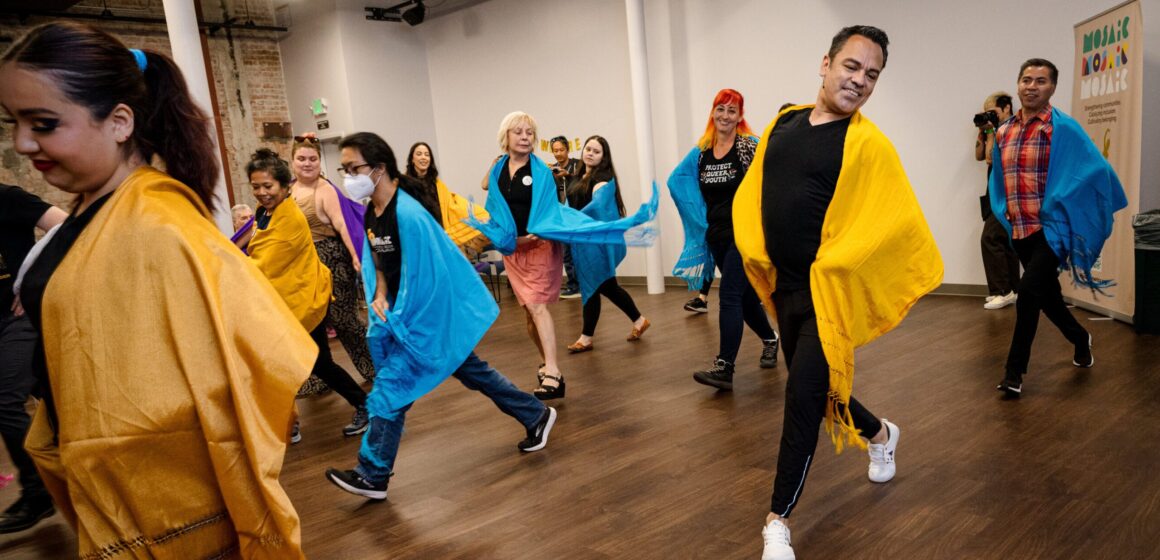 A group of people learning to dance indoors