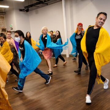 A group of people learning to dance indoors