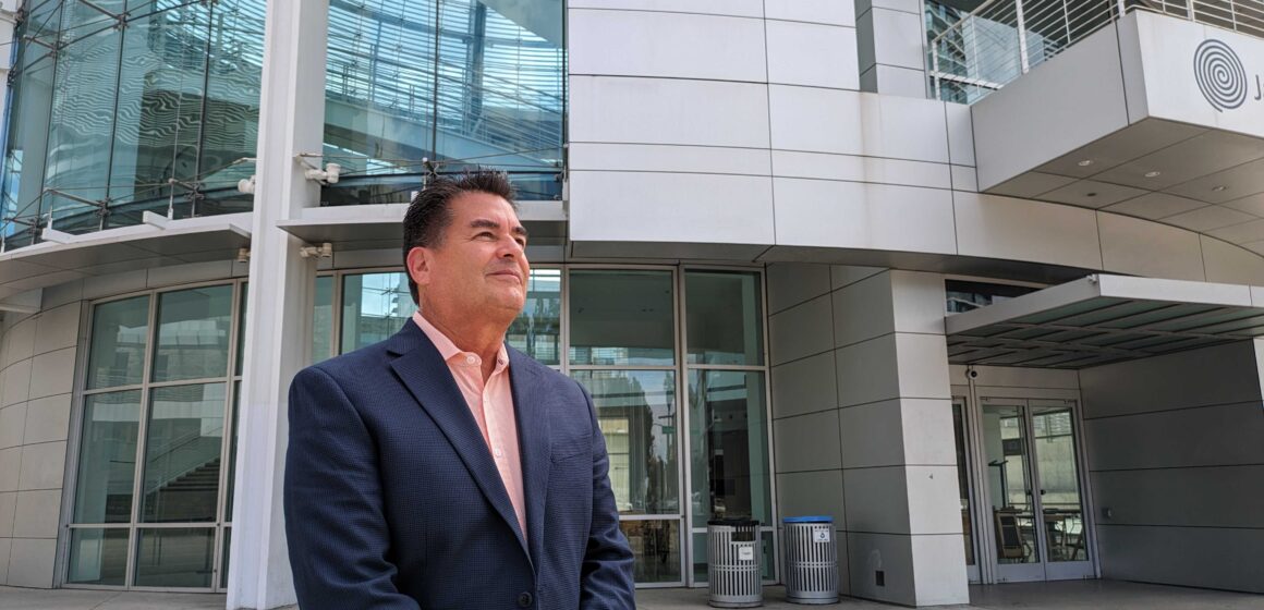 SCOTT HUGHES - SAN JOSE DISTRICT 9 COUNCIL CANDIDATE An older man in a suit jacket looks into the distance in front of a big, silver rotunda