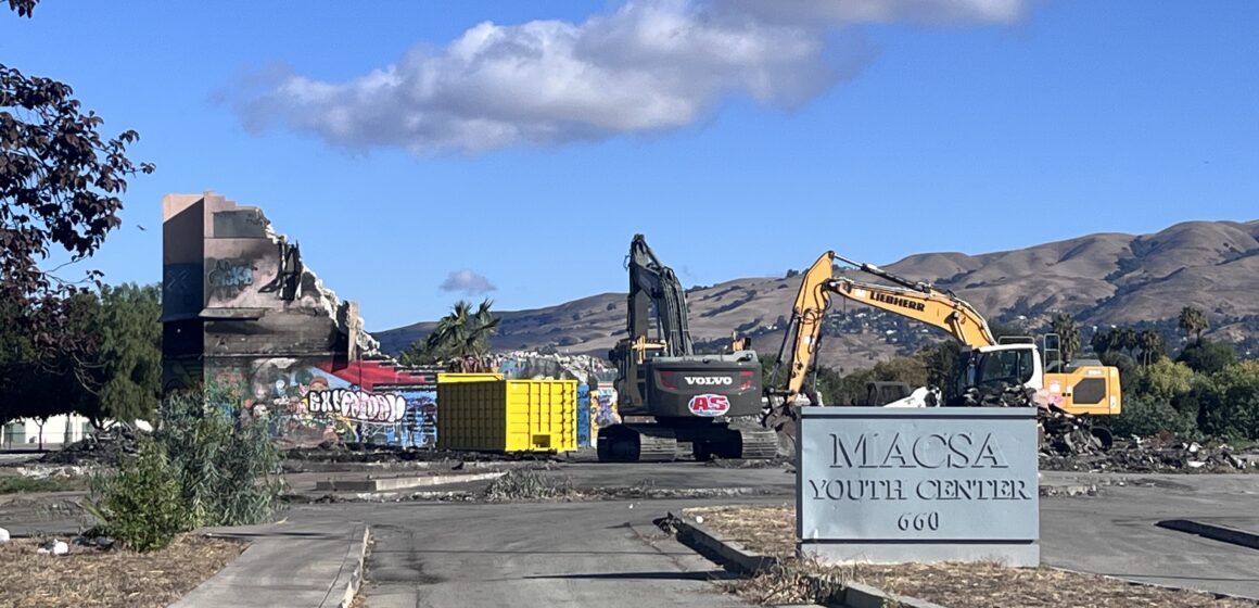 Excavators demolish a vacant former youth center in East San Jose, California