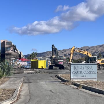 Excavators demolish a vacant former youth center in East San Jose, California