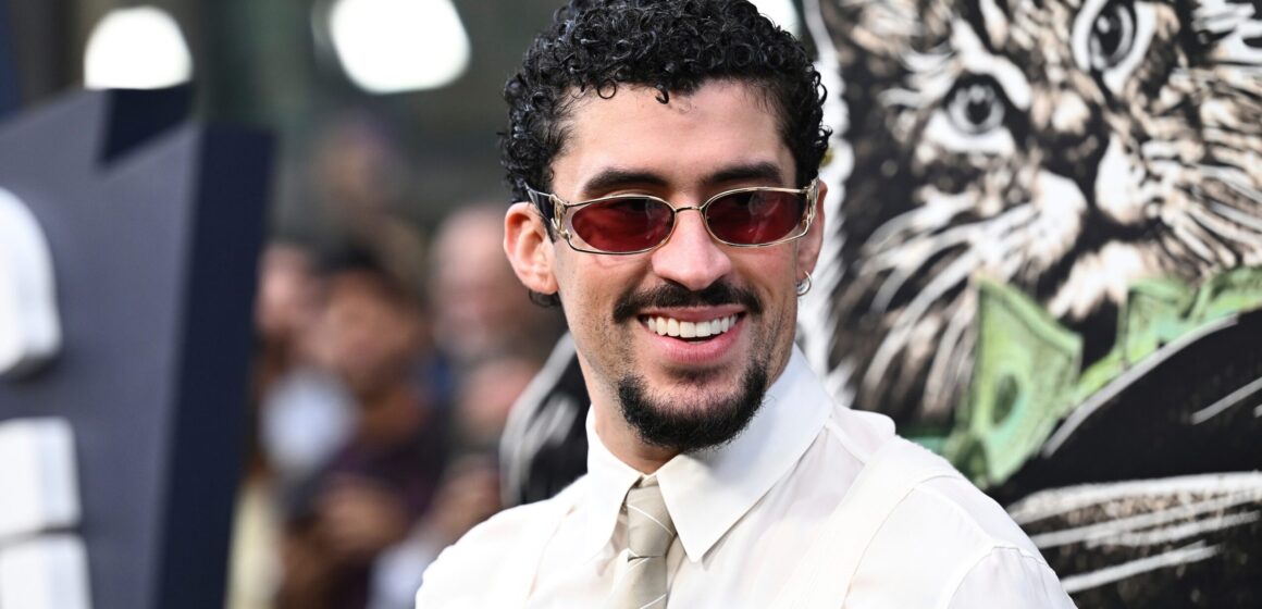 Music artist Bad Bunny in a shirt and tie wearing sunglasses