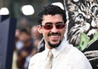 Music artist Bad Bunny in a shirt and tie wearing sunglasses