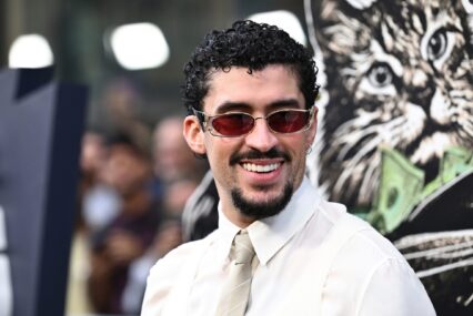 Music artist Bad Bunny in a shirt and tie wearing sunglasses