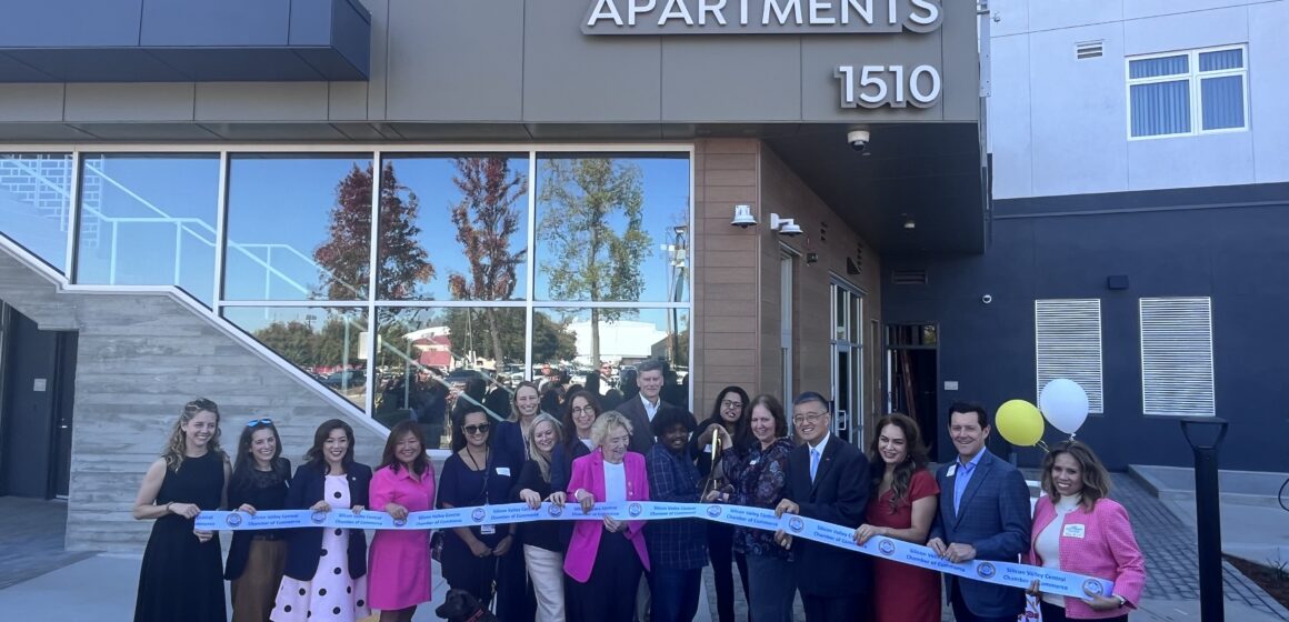 PARKMOOR COMMUNITY APTS A group of people stand in a line behind a ribbon, with some holding large scissors, in San Jose, California