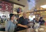 A man and a woman stand behind the counter at a restaurant in San Jose, California