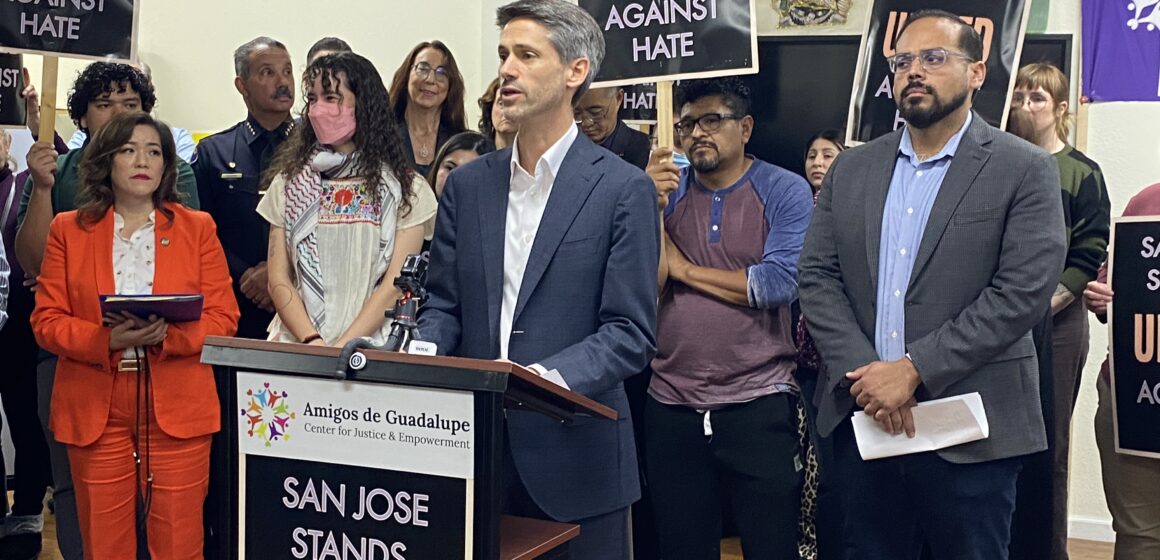 Mayor Matt Mahan responds to federal deployment news A man in a suit stands at a podium in front of a group of people.