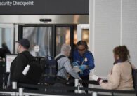 People go through a TSA checkpoint at an airport