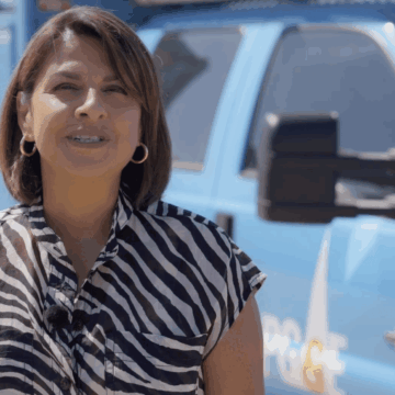 ALVARADO A woman standing in front of a PG&E utility truck