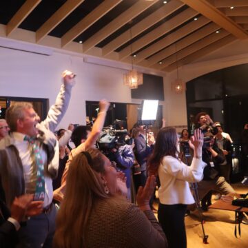 A crowd cheering at an election night watch party in San Jose, California