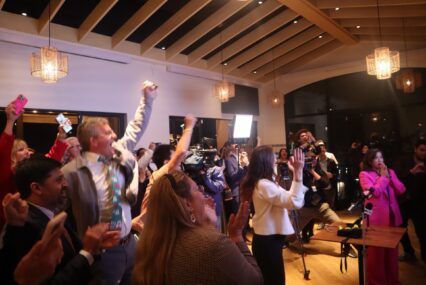 A crowd cheering at an election night watch party in San Jose, California
