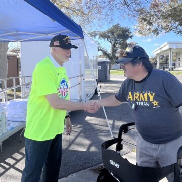 VET RESOURCE FAIR Two veterans shake hands outdoors at a resource fair in Santa Clara County, California