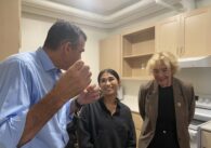 Three people stand inside an apartment in San Jose, California